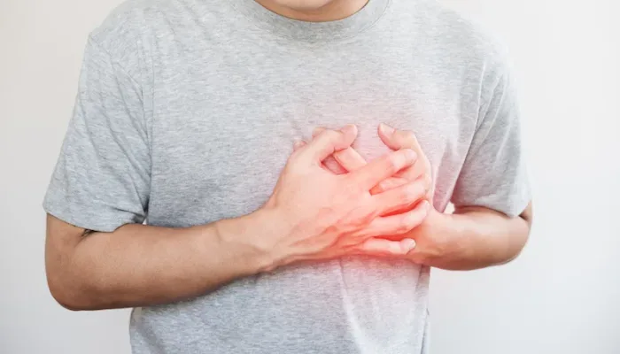 a man touching his heart, with red highlight of heart attack, and others heart disease concept, on white background