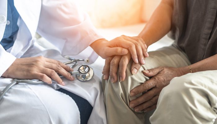 Parkinson's disease patient, Arthritis hand and knee pain or mental health care concept with geriatric doctor consulting examining elderly senior aged adult in medical exam clinic or hospital